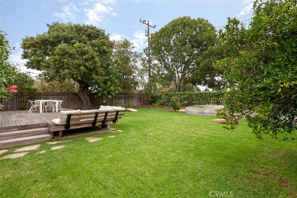 a view of a park with trees and wooden fence