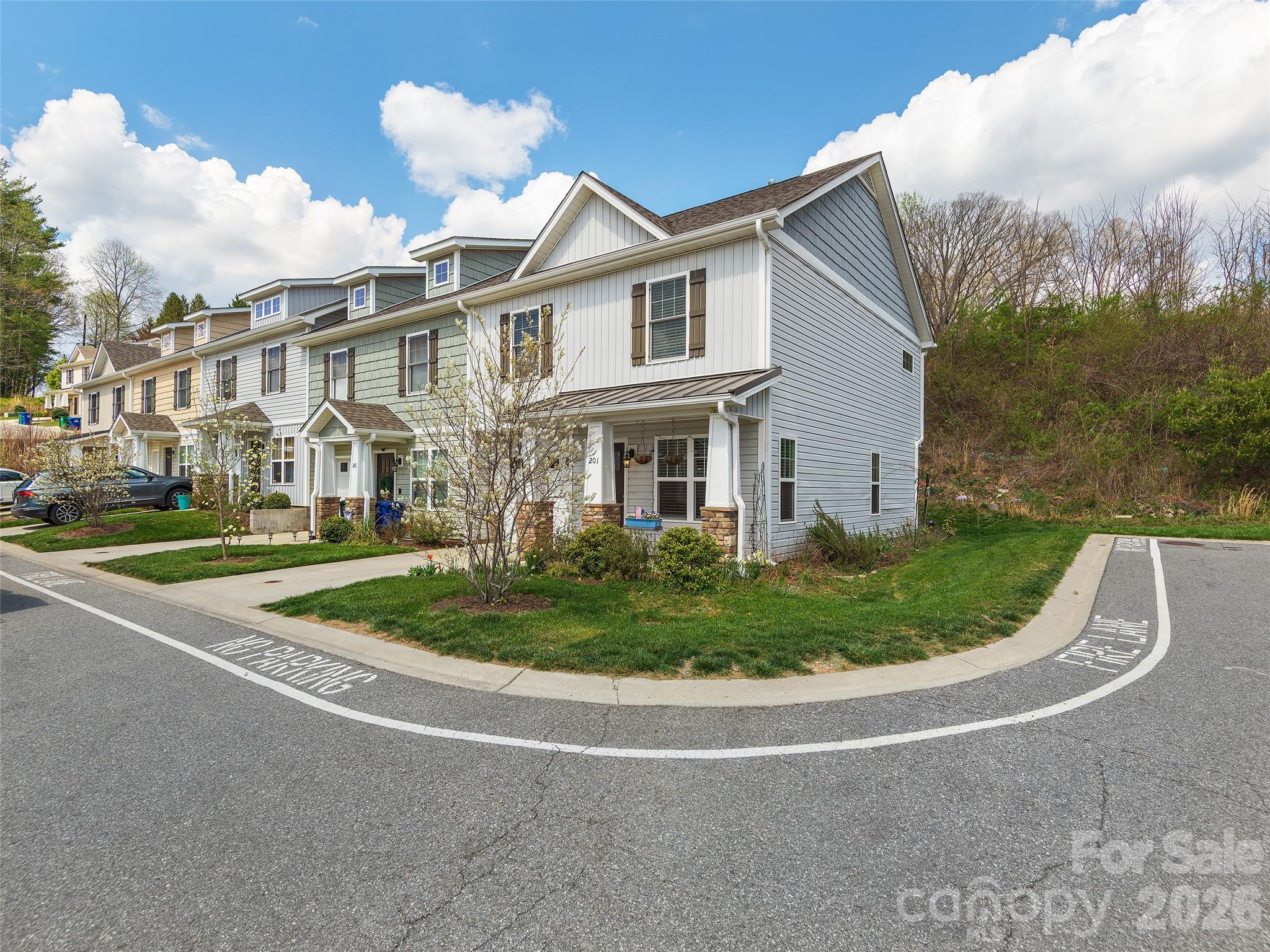 201 Stoney Point Way Candler, NC 28715 - Photo 2 of 18 a front view of a house with a garden