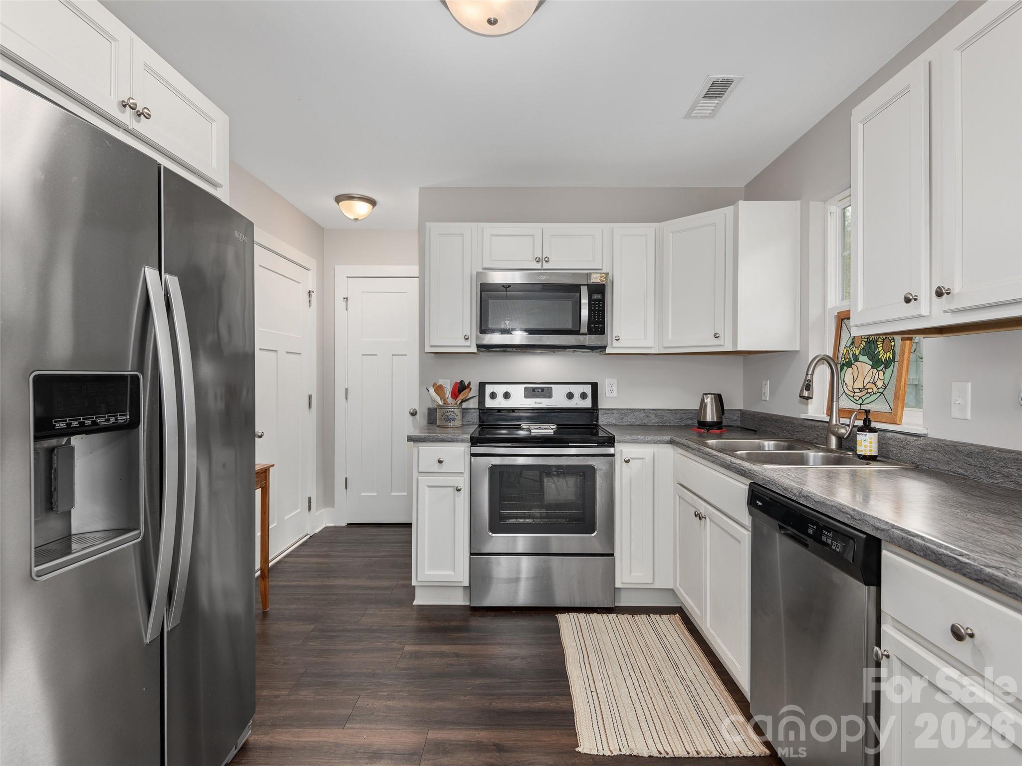 201 Stoney Point Way Candler, NC 28715 - Photo 8 of 18 a kitchen with a refrigerator stove and sink