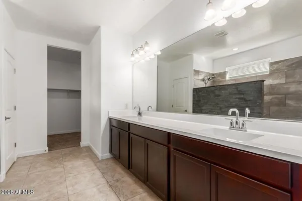 a bathroom with a sink double vanity and a mirror
