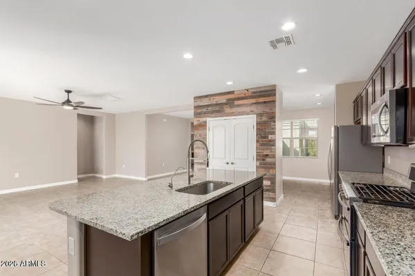 a kitchen with granite countertop a sink and cabinets