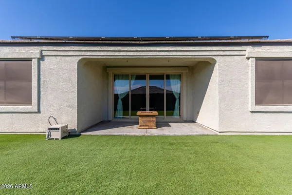 a view of a house with backyard and porch