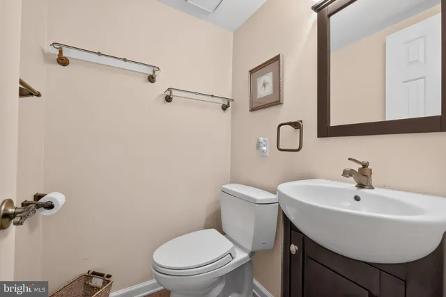 a bathroom with a sink a toilet and a mirror