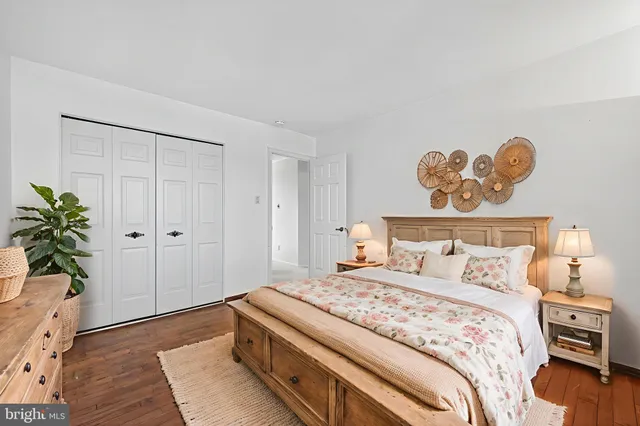 a bedroom with a bed and a potted plant