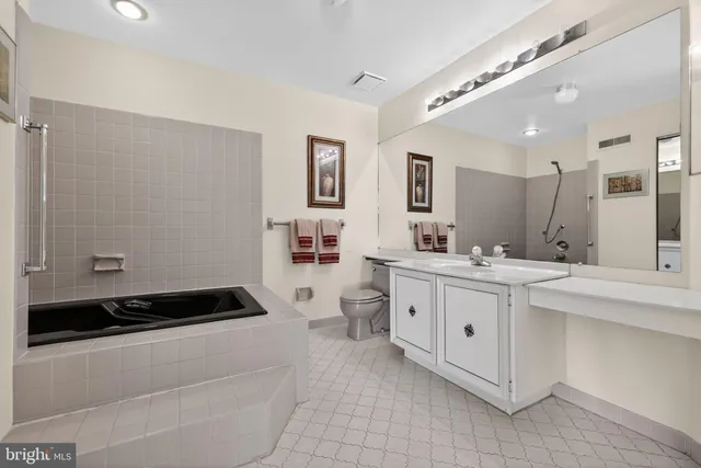 a spacious bathroom with a double vanity sink a mirror and a