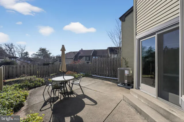 a view of a chairs and table in backyard of the house