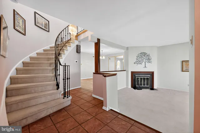 a view of a livingroom with wooden floor and a fireplace