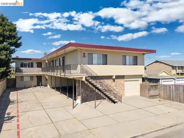 a view of a house with a wrought fence