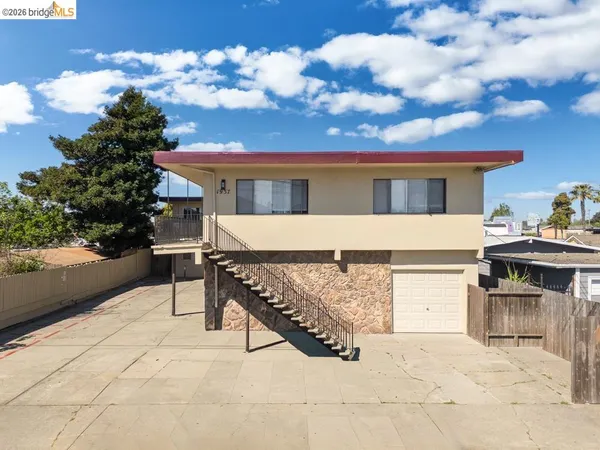 a view of a white house with a yard