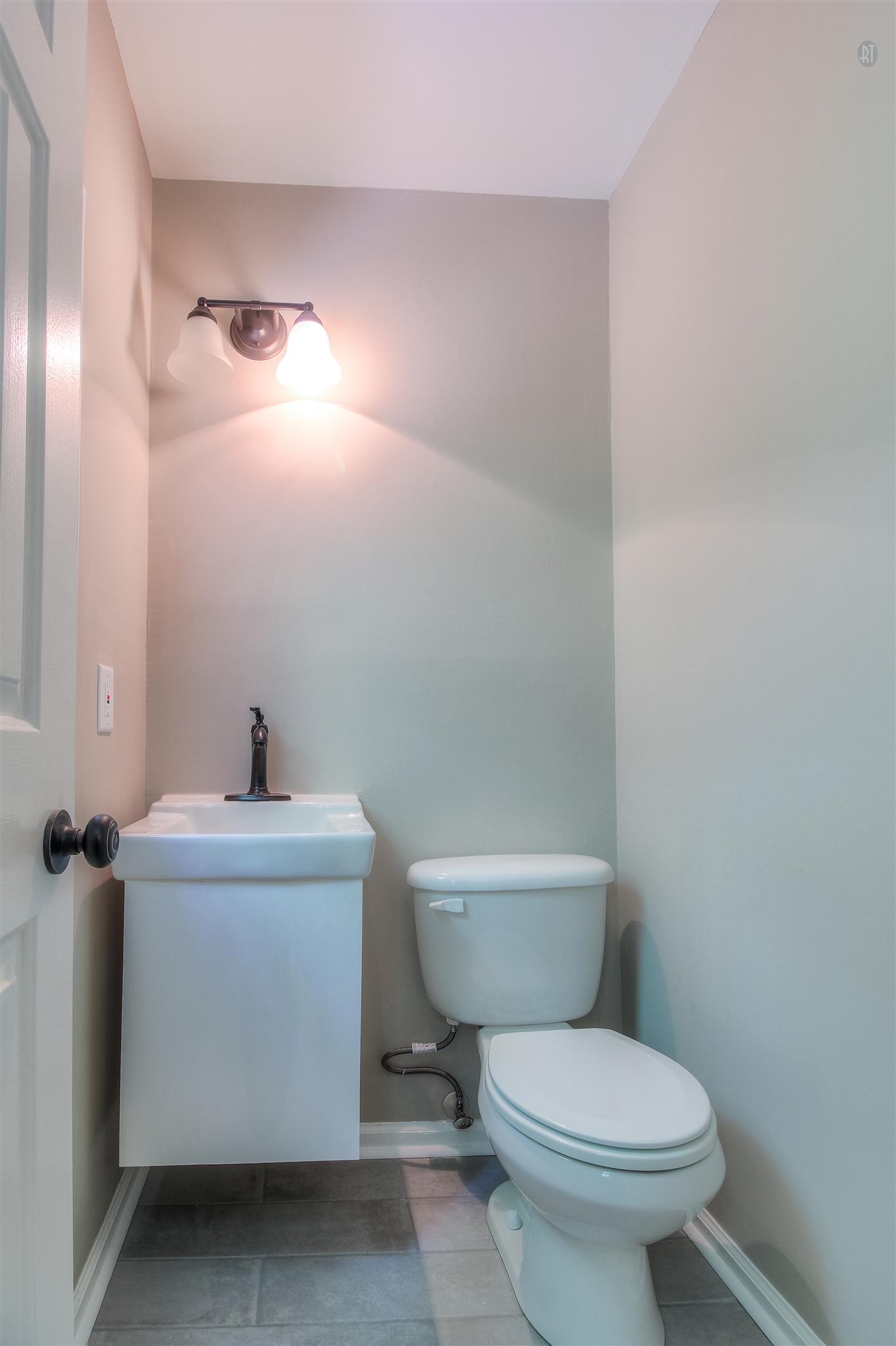 304 Warrior Road Madison, TN 37115 - Photo 10 of 16 A half bath features a custom tiled floor.