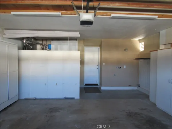 a dining room with furniture and a floor to ceiling window