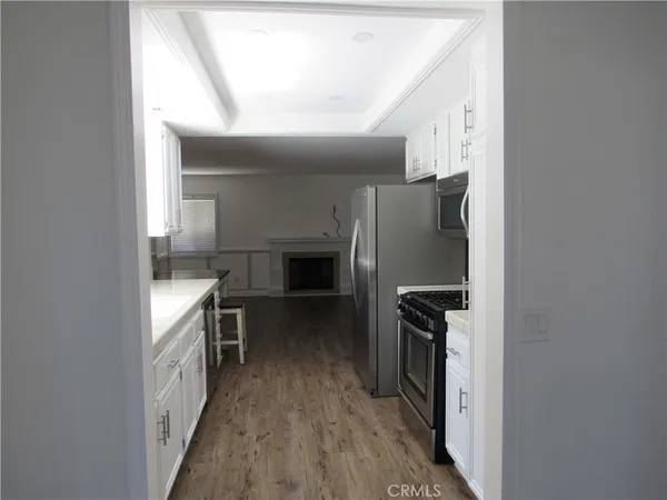 a kitchen with a refrigerator and a stove