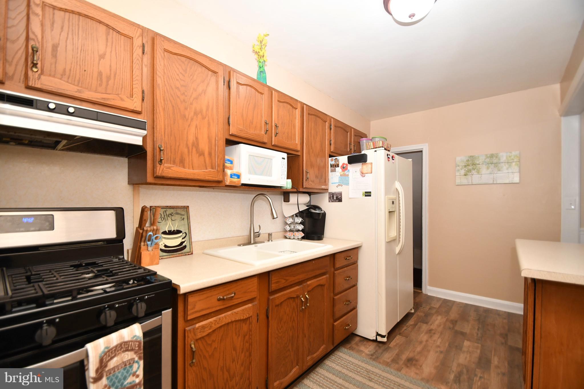 58 Berkshire Road Baltimore, MD 21221 - Photo 15 of 41 a kitchen with stainless steel appliances granite countertop a refrigerator stove and sink