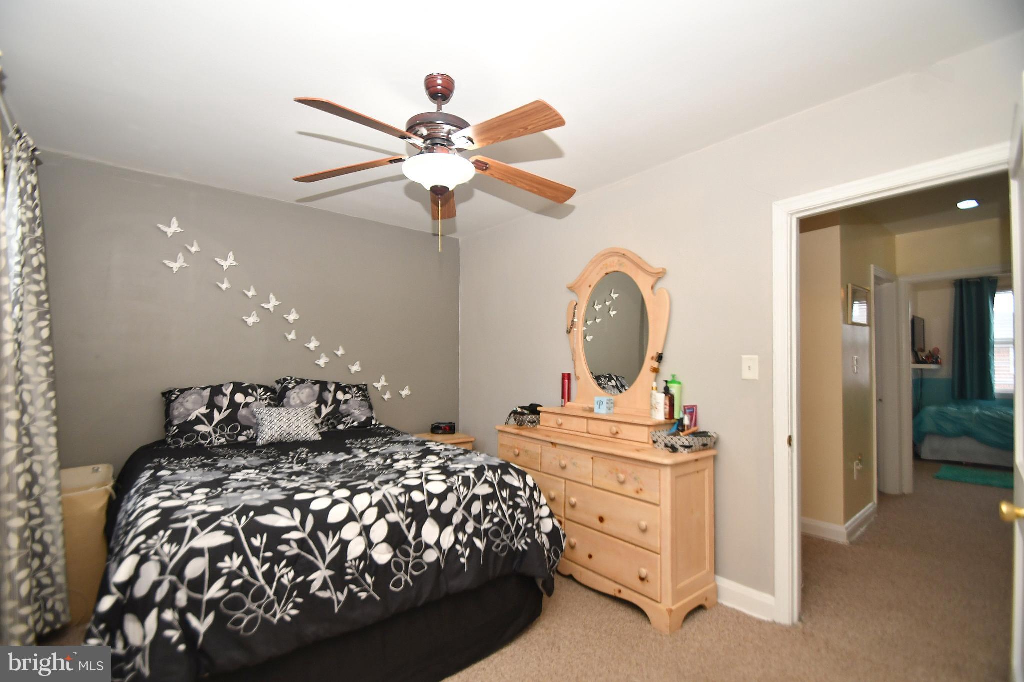 58 Berkshire Road Baltimore, MD 21221 - Photo 16 of 41 a bedroom with a bed and a chandelier