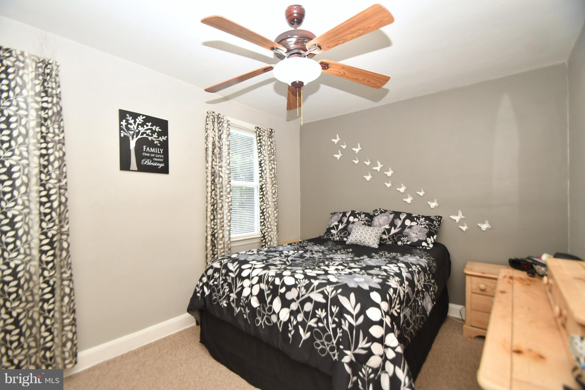 58 Berkshire Road Baltimore, MD 21221 - Photo 17 of 41 a bedroom with a bed and a chandelier