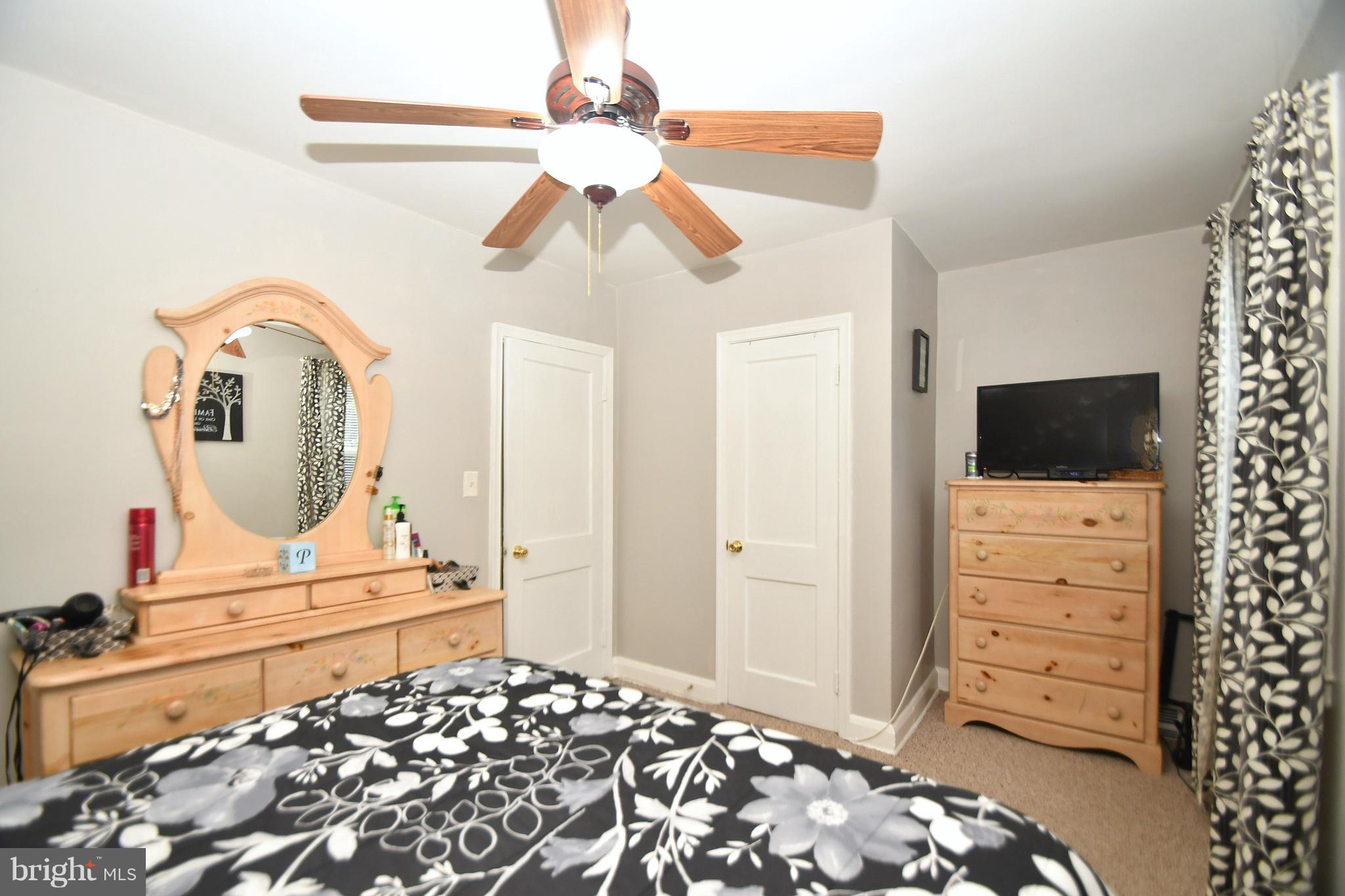 58 Berkshire Road Baltimore, MD 21221 - Photo 19 of 41 a bedroom with a bed and flat screen tv