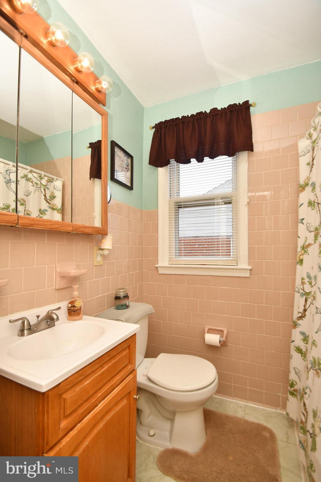 58 Berkshire Road Baltimore, MD 21221 - Photo 20 of 41 a bathroom with a sink and a mirror