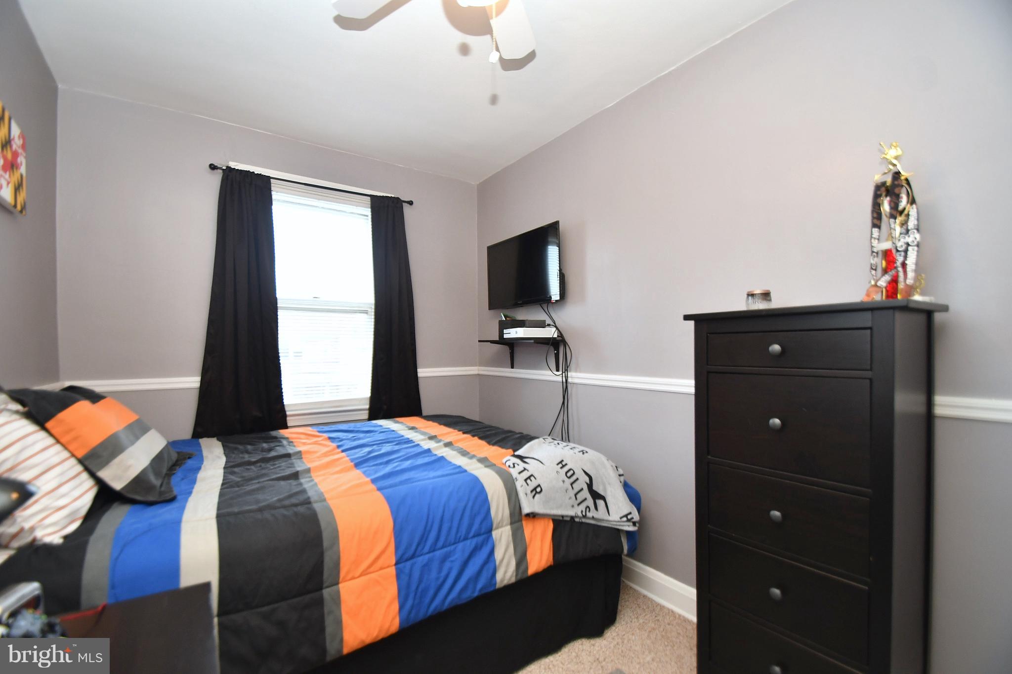 58 Berkshire Road Baltimore, MD 21221 - Photo 21 of 41 a bedroom with a bed and a chandelier