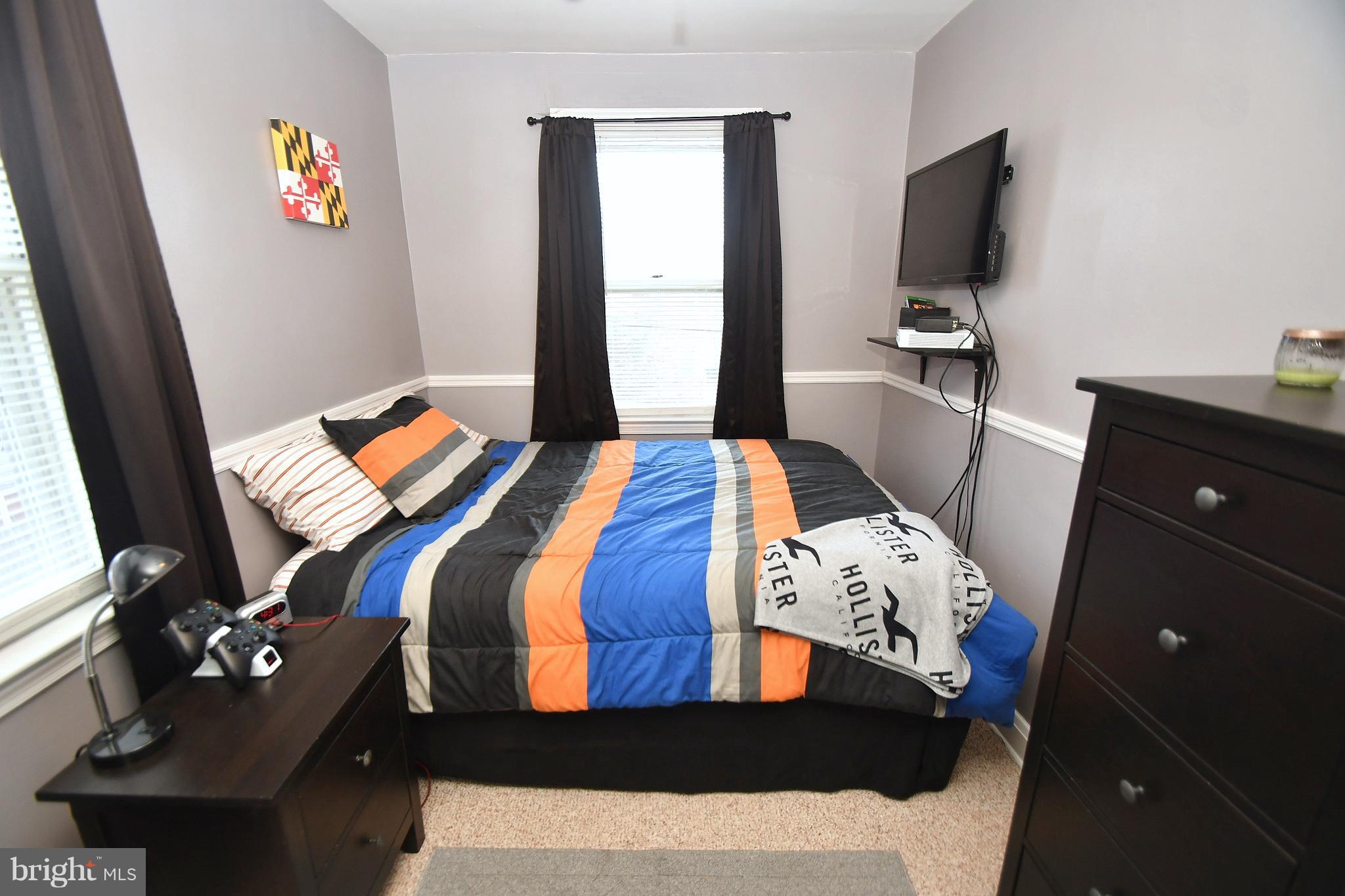 58 Berkshire Road Baltimore, MD 21221 - Photo 22 of 41 a bedroom with a bed and a flat screen tv