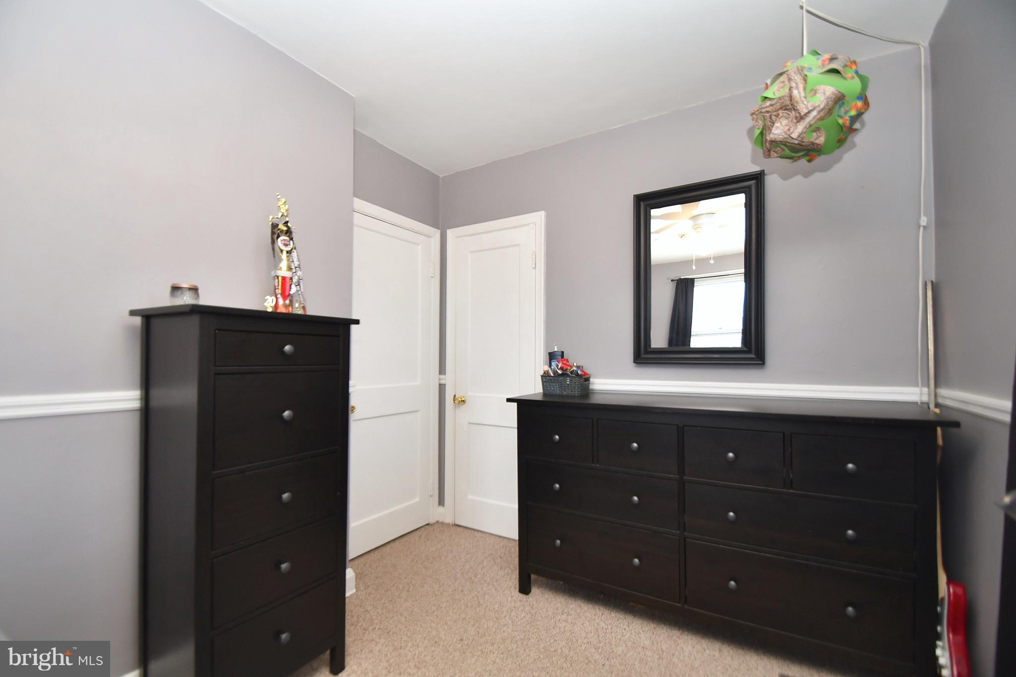 58 Berkshire Road Baltimore, MD 21221 - Photo 24 of 41 a room with a dresser and a mirror