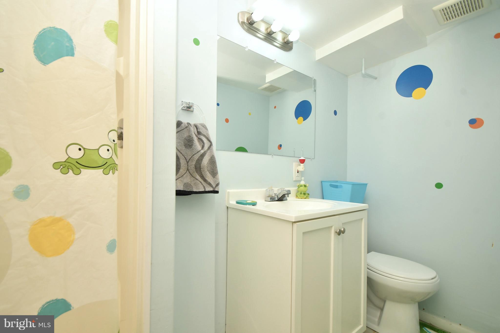 58 Berkshire Road Baltimore, MD 21221 - Photo 32 of 41 a bathroom with a sink mirror and toilet
