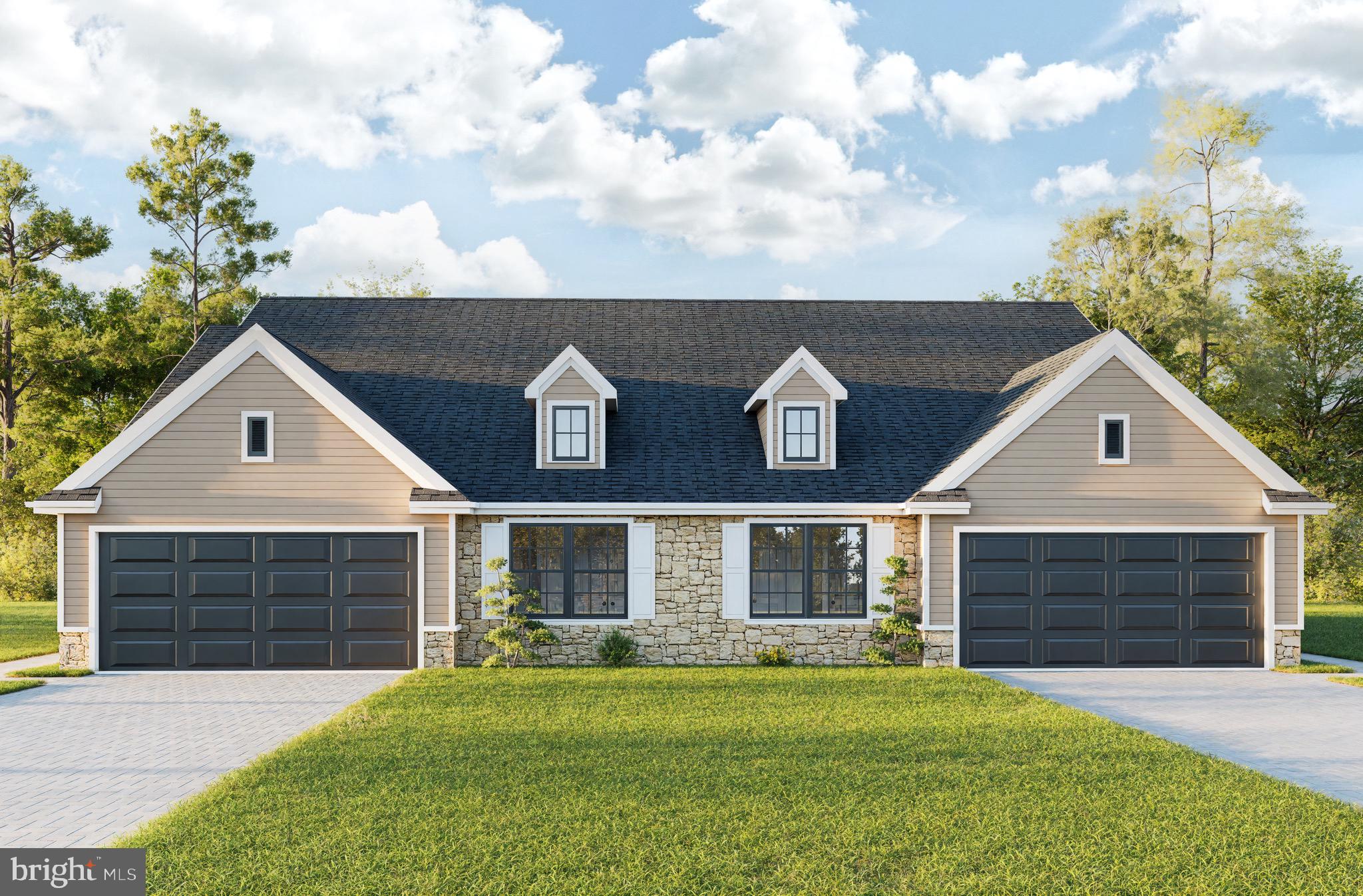 a front view of a house with a garden and yard