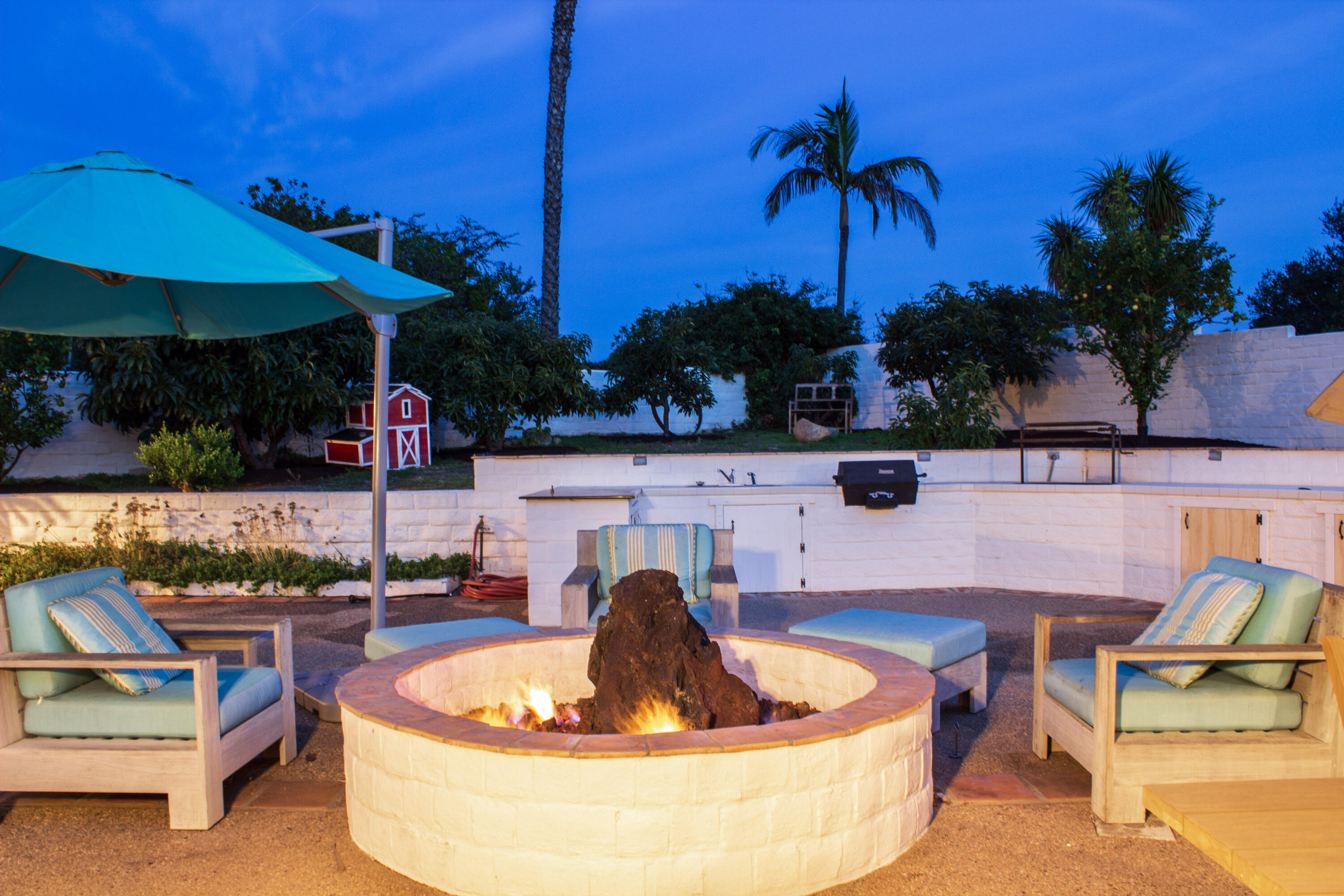 4620 Via Rubi Santa Barbara, CA 93105 - Photo 18 of 18 a backyard of a house with a table and chairs under an umbrella