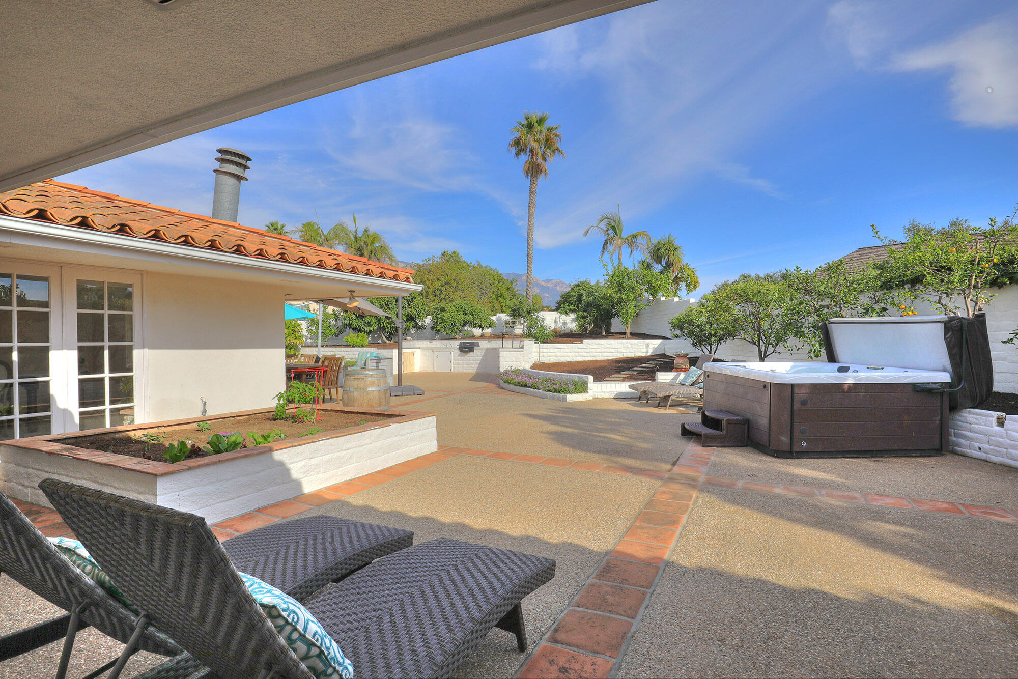 4620 Via Rubi Santa Barbara, CA 93105 - Photo 6 of 18 a view of a patio with a table and chairs and potted plants