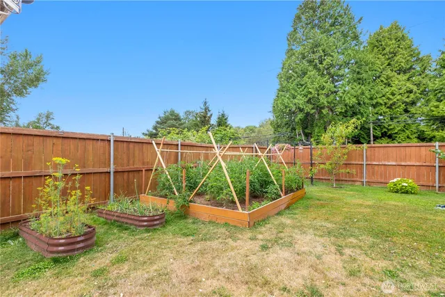 a view of a backyard with a garden and entertaining space