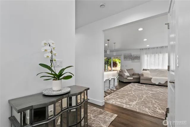 a living room with furniture and a potted plant