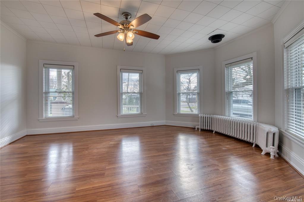 775 Hummel Avenue, Unit A Southold, NY 11971 - Photo 2 of 11 a view of an empty room with wooden floor and a window