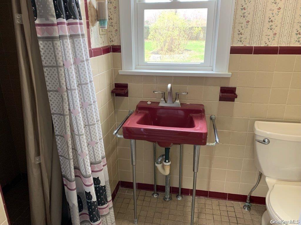 775 Hummel Avenue, Unit A Southold, NY 11971 - Photo 5 of 11 a bathroom with a toilet and a sink