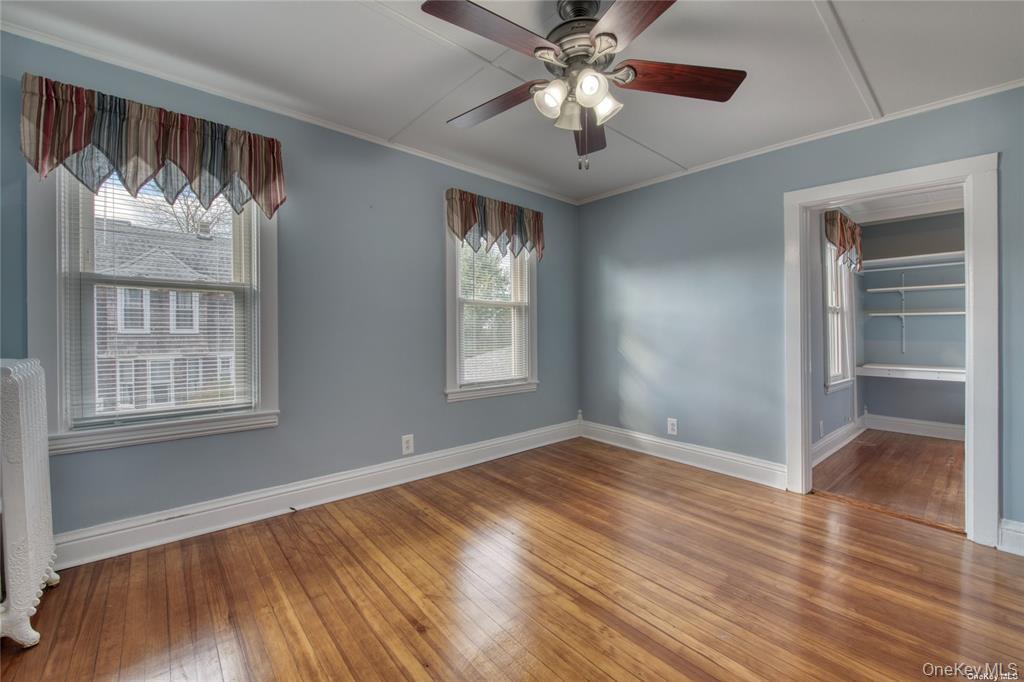 775 Hummel Avenue, Unit A Southold, NY 11971 - Photo 7 of 11 wooden floor in an empty room with a window