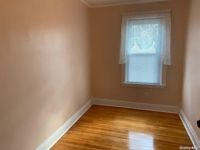 a view of a room with wooden floor and windows