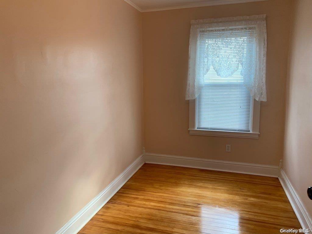 775 Hummel Avenue, Unit A Southold, NY 11971 - Photo 9 of 11 a view of a room with wooden floor and windows