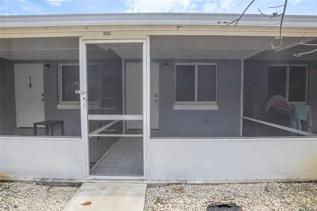 a kitchen with a refrigerator a stove top oven and cabinets