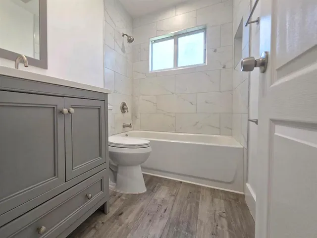 a view of room with window and wooden floor