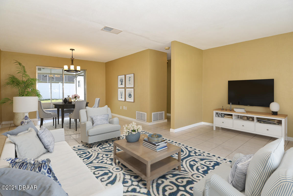 25 Tula Drive Port Orange, FL 32129 - Photo 2 of 49 a living room with furniture and a flat screen tv