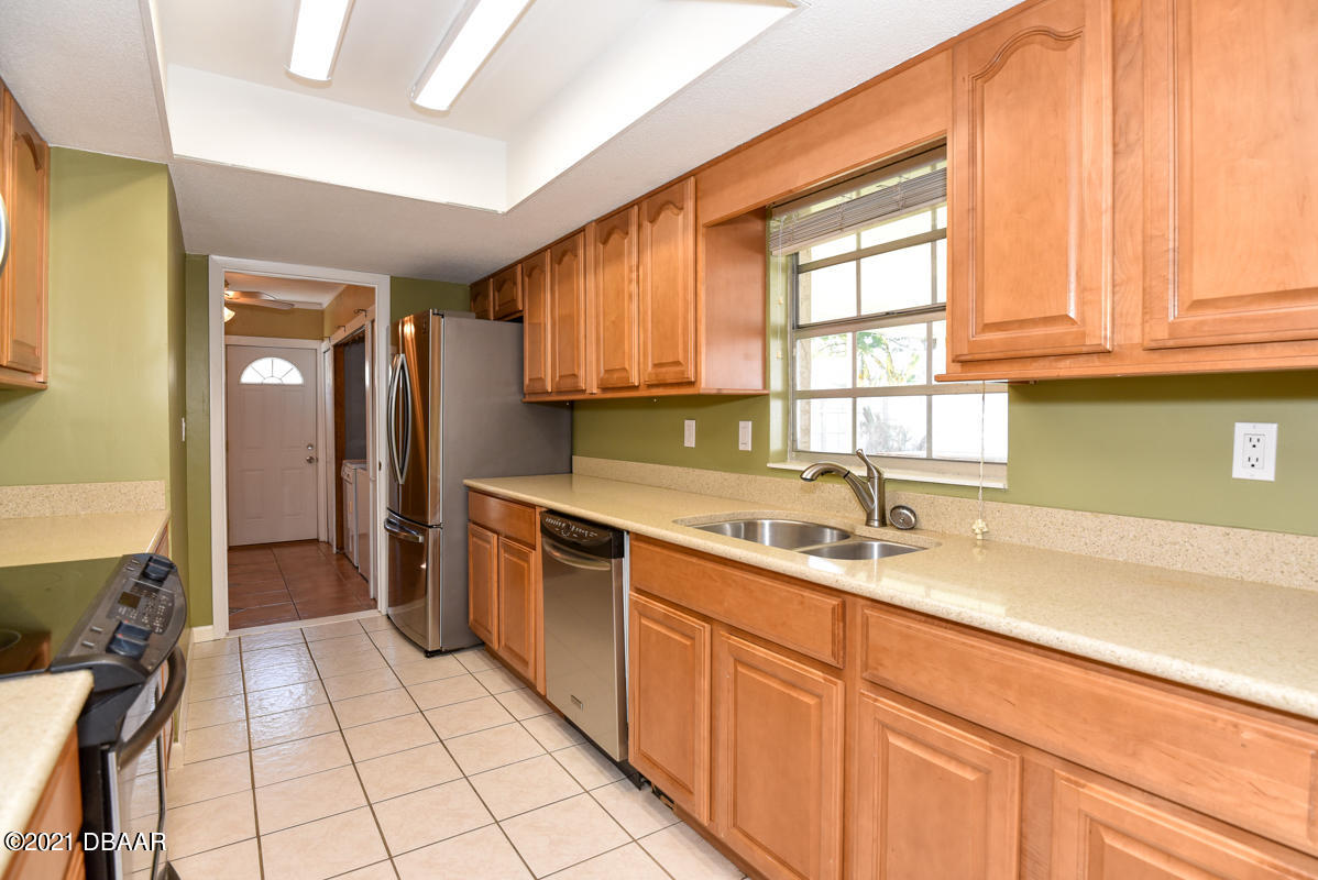 25 Tula Drive Port Orange, FL 32129 - Photo 21 of 49 a kitchen with a sink cabinets and window