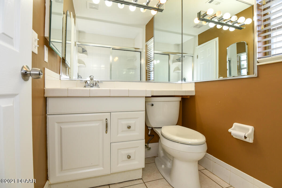 25 Tula Drive Port Orange, FL 32129 - Photo 38 of 49 a bathroom with a sink a toilet a mirror and shower