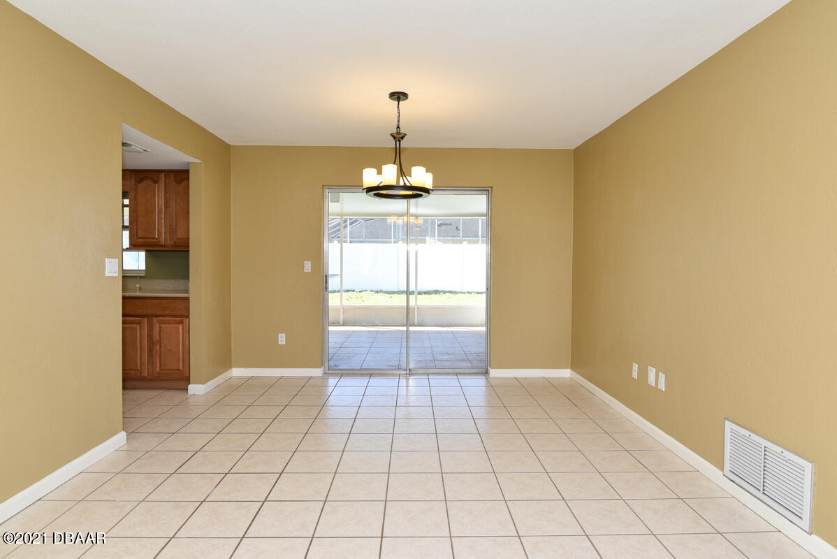 25 Tula Drive Port Orange, FL 32129 - Photo 42 of 49 a view of a room with a chandelier fan and windows