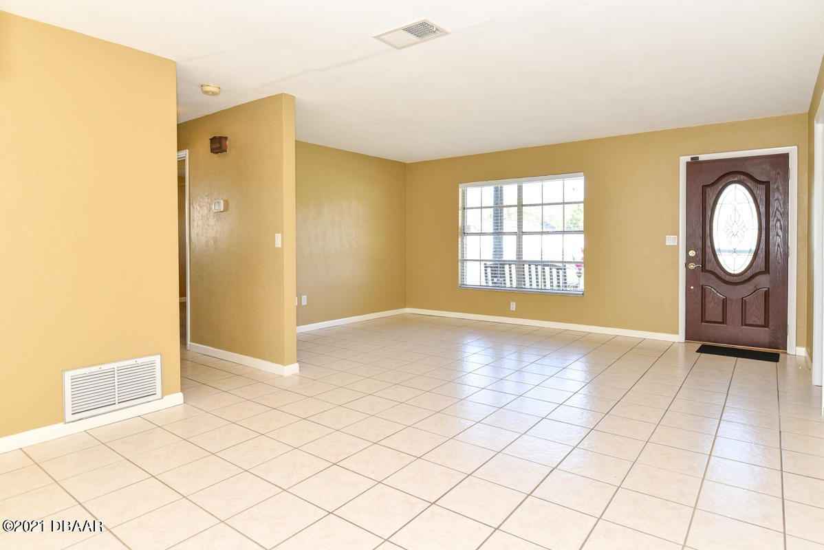 25 Tula Drive Port Orange, FL 32129 - Photo 44 of 49 a view of an empty room with a fireplace and a window