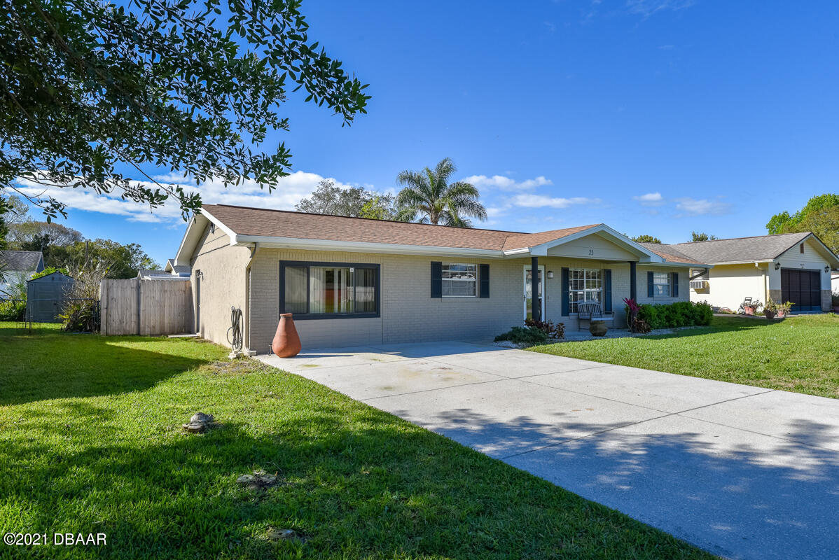 25 Tula Drive Port Orange, FL 32129 - Photo 8 of 49 a front view of a house with a garden