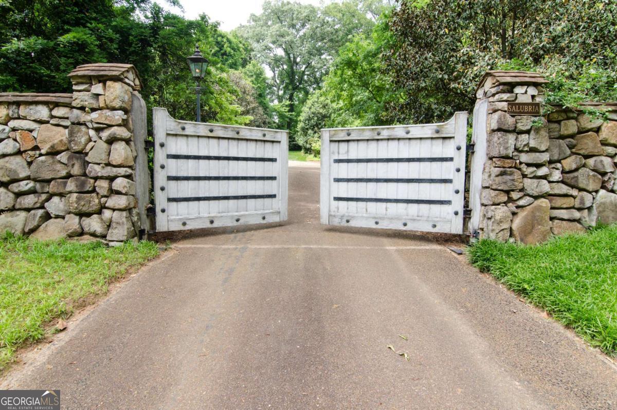 2100 West Wesley Road Northwest Atlanta, GA 30327 - Photo 2 of 53 a view of a wooden house with a street view