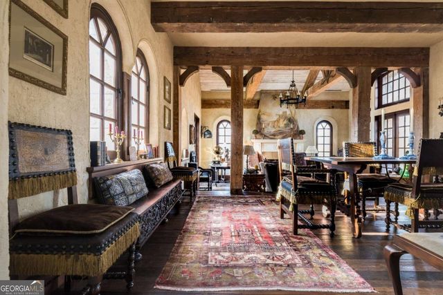 a living room with fireplace furniture and a floor to ceiling window
