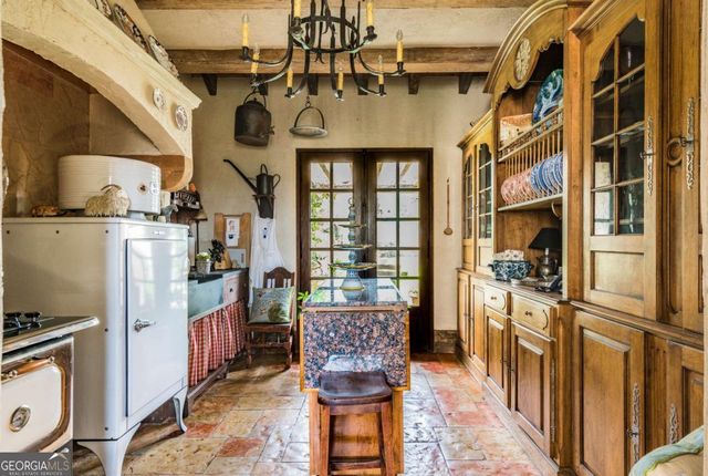 a living room with furniture a fireplace and large windows