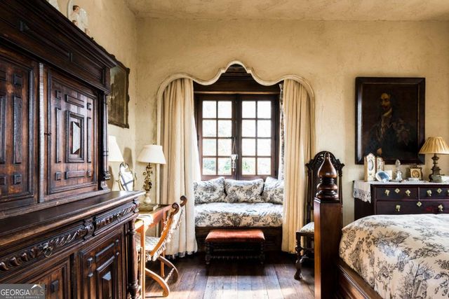 a bed sitting in a bedroom next to a window