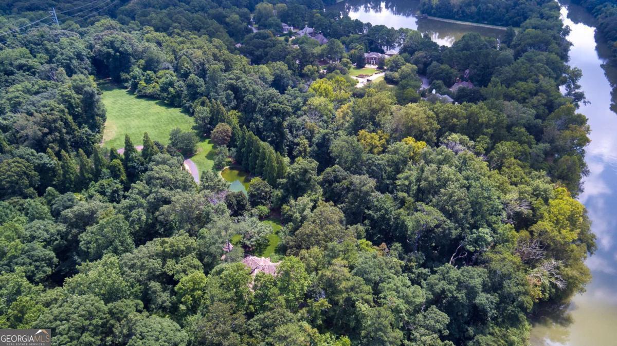 2100 West Wesley Road Northwest Atlanta, GA 30327 - Photo 44 of 53 a view of a house with a lush green forest