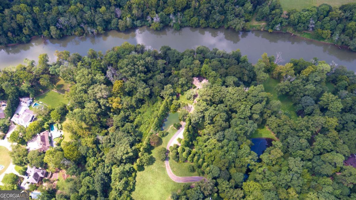 2100 West Wesley Road Northwest Atlanta, GA 30327 - Photo 49 of 53 an aerial view of a house with a yard and lake view