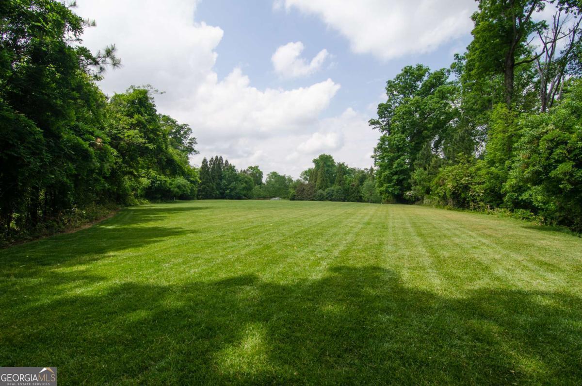 2100 West Wesley Road Northwest Atlanta, GA 30327 - Photo 6 of 53 a view of a green field with wooden fence